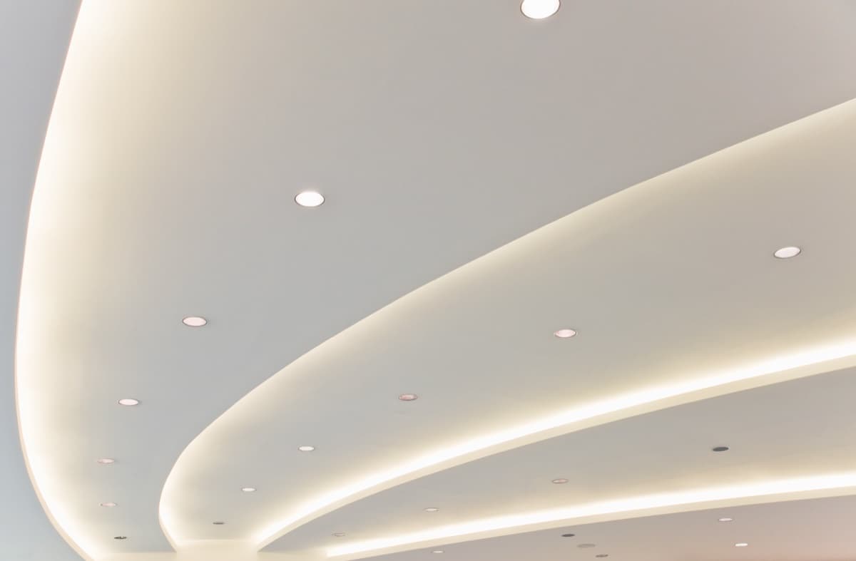 Curved ceiling with LED strip lighting and downlights