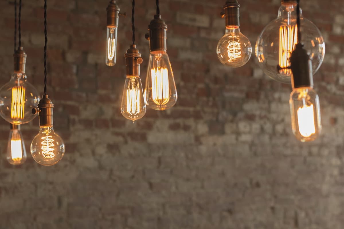 Vintage filament pendant bulbs against a brick wall